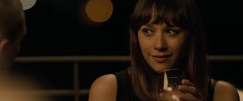Movie still from “Celeste & Jesse Forever” (2012), directed by Lee Toland Krieger – A beautiful young lady holding a glass of wine; Close Up shot, Over the shoulder angle