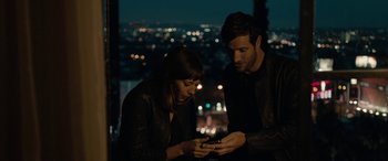 Movie still from “Celeste & Jesse Forever” (2012), directed by Lee Toland Krieger – A man and a woman looking at a cell phone; Medium shot, High angle