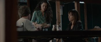 Movie still from “Celeste & Jesse Forever” (2012), directed by Lee Toland Krieger – A woman standing in front of two other people; Medium shot, Over the shoulder angle