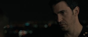 Movie still from “Celeste & Jesse Forever” (2012), directed by Lee Toland Krieger – A man's face in the dark; Close Up shot, Over the shoulder angle