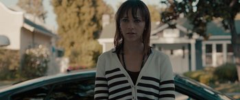 Movie still from “Celeste & Jesse Forever” (2012), directed by Lee Toland Krieger – A woman standing in front of a car on a street; Close Up shot, Over the shoulder angle