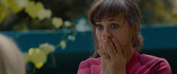 Movie still from “Celeste & Jesse Forever” (2012), directed by Lee Toland Krieger – A person covering her mouth; Close Up shot, Over the shoulder angle