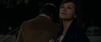 Movie still from “Celeste & Jesse Forever” (2012), directed by Lee Toland Krieger – A woman standing next to a man in a brown suit; Close Up shot, Over the shoulder angle