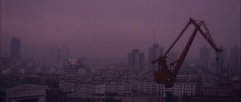 Movie still from “Code 46” (2003), directed by Michael Winterbottom – A view of a city from a hill at night; Extreme Wide shot, Low angle