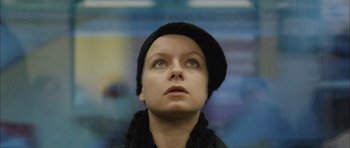 Movie still from “Code 46” (2003), directed by Michael Winterbottom – A person wearing a hat looking up; Close Up shot, Low angle