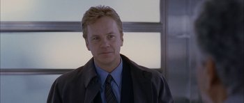 Movie still from “Code 46” (2003), directed by Michael Winterbottom – A person wearing a suit and tie; Close Up shot, Low angle
