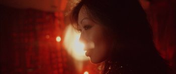 Movie still from “Code 46” (2003), directed by Michael Winterbottom – A woman's face in front of lights; Extreme Close Up shot, Low angle