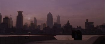 Movie still from “Code 46” (2003), directed by Michael Winterbottom – A view of a city skyline at sunset; Extreme Wide shot, Low angle