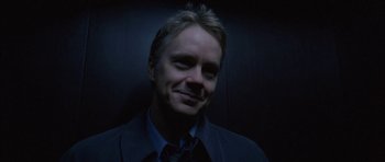 Movie still from “Code 46” (2003), directed by Michael Winterbottom – A person wearing a suit and tie; Close Up shot, Low angle