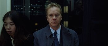Movie still from “Code 46” (2003), directed by Michael Winterbottom – A person wearing a suit and tie; Close Up shot, Over the shoulder angle