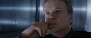 Movie still from “Code 46” (2003), directed by Michael Winterbottom – A person with his hand under his chin; Close Up shot, Low angle