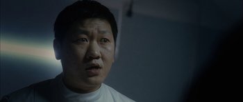 Movie still from “Code 46” (2003), directed by Michael Winterbottom – A person wearing a white t - shirt; Close Up shot, Low angle