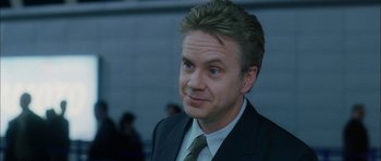 Movie still from “Code 46” (2003), directed by Michael Winterbottom – A person wearing a suit and tie; Close Up shot, Over the shoulder angle