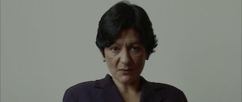 Movie still from “Code 46” (2003), directed by Michael Winterbottom – A person with short hair; Close Up shot, Low angle