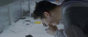 Movie still from “Code 46” (2003), directed by Michael Winterbottom – A man is looking down at a cell phone; Extreme Close Up shot, High angle