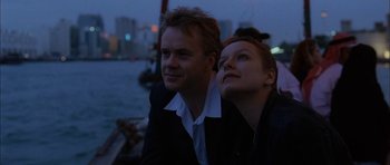 Movie still from “Code 46” (2003), directed by Michael Winterbottom – A man and a woman sitting next to each other on a boat; Close Up shot, Low angle