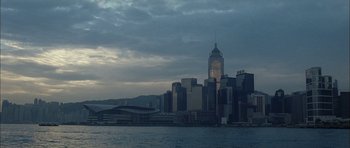 Movie still from “Code 46” (2003), directed by Michael Winterbottom – A view of a city skyline from across a body of water; Extreme Wide shot, High angle