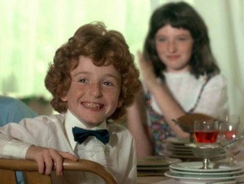 Movie still from “Cousin cousine” (1975), directed by Jean-Charles Tacchella – A boy and a girl sitting at a dinner table; Close Up shot, Over the shoulder angle