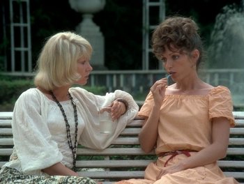 Movie still from “Cousin cousine” (1975), directed by Jean-Charles Tacchella – Two women sitting on a park bench one of which is smoking a cigarette; Medium shot, High angle