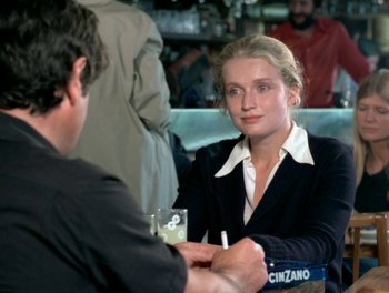 Movie still from “Cousin cousine” (1975), directed by Jean-Charles Tacchella – A woman sitting at a table with a man; Medium shot, Over the shoulder angle