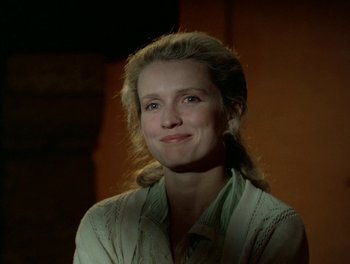 Movie still from “Cousin cousine” (1975), directed by Jean-Charles Tacchella – A woman in a green shirt is smiling for the camera; Close Up shot, Over the shoulder angle