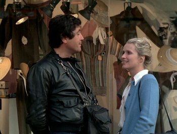 Movie still from “Cousin cousine” (1975), directed by Jean-Charles Tacchella – A man and a woman standing next to each other; Medium shot, Over the shoulder angle