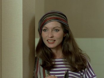Movie still from “Cousin cousine” (1975), directed by Jean-Charles Tacchella – A woman in a striped shirt holding a pair of scissors; Close Up shot, High angle