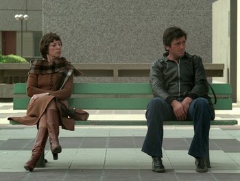 Movie still from “Cousin cousine” (1975), directed by Jean-Charles Tacchella – A man and a woman sitting on a bench; Wide shot, Low angle