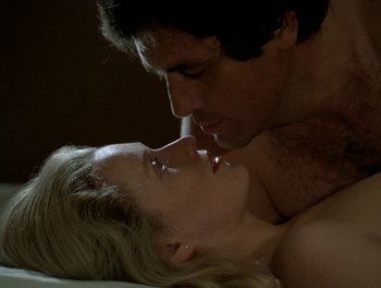 Movie still from “Cousin cousine” (1975), directed by Jean-Charles Tacchella – A man and a woman laying on a bed kissing; Close Up shot, High angle