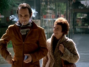 Movie still from “Cousin cousine” (1975), directed by Jean-Charles Tacchella – A man and a woman walking down a street; Medium shot, Low angle