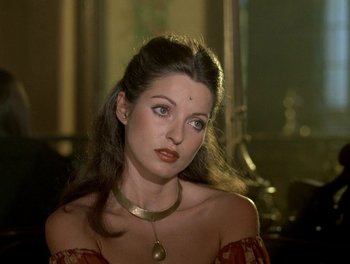 Movie still from “Cousin cousine” (1975), directed by Jean-Charles Tacchella – A beautiful woman wearing a gold necklace and a red dress; Close Up shot, High angle