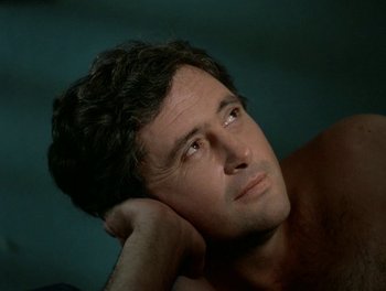 Movie still from “Cousin cousine” (1975), directed by Jean-Charles Tacchella – A person with his hand under his chin; Close Up shot, High angle