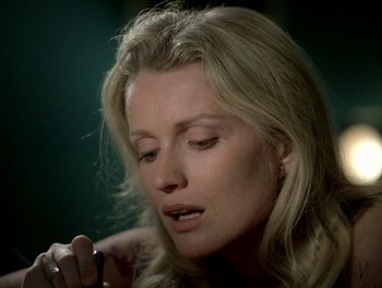 Movie still from “Cousin cousine” (1975), directed by Jean-Charles Tacchella – A beautiful blonde woman looking down at a cell phone; Close Up shot, High angle