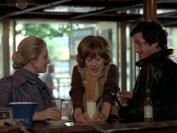 Movie still from “Cousin cousine” (1975), directed by Jean-Charles Tacchella – A group of people sitting at a table with drinks; Medium shot, High angle