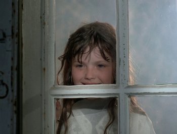 Movie still from “Cousin cousine” (1975), directed by Jean-Charles Tacchella – A young girl looking through a window; Close Up shot, Low angle