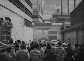Movie still from “Dodsworth” (1936), directed by William Wyler – A black and white photo of a group of people walking down a street; Extreme Wide shot, High angle