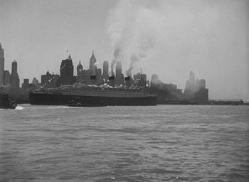 Movie still from “Dodsworth” (1936), directed by William Wyler – A large ship in a body of water near a city; Extreme Wide shot, Low angle