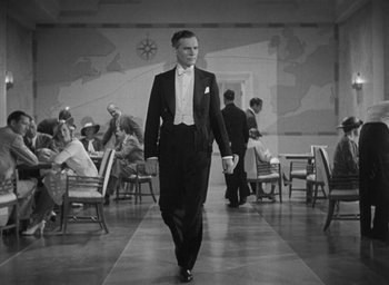 Movie still from “Dodsworth” (1936), directed by William Wyler – A man walking down a runway in a tuxedo; Medium shot, Low angle