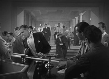 Movie still from “Dodsworth” (1936), directed by William Wyler – A black and white photo of people sitting at a table; Wide shot, High angle