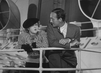 Movie still from “Dodsworth” (1936), directed by William Wyler – An older man standing next to an older woman on a boat; Medium shot, Low angle