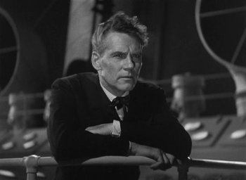 Movie still from “Dodsworth” (1936), directed by William Wyler – Black and white photograph of a man in a suit; Close Up shot, Low angle
