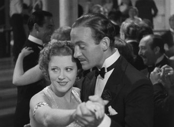 Movie still from “Dodsworth” (1936), directed by William Wyler – A man and a woman are dancing in a crowd; Medium shot, Low angle