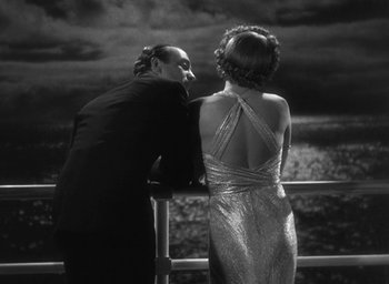 Movie still from “Dodsworth” (1936), directed by William Wyler – A man and a woman standing next to a railing; Medium shot, Low angle