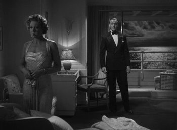 Movie still from “Dodsworth” (1936), directed by William Wyler – A man and a woman standing in front of a window; Wide shot, Low angle