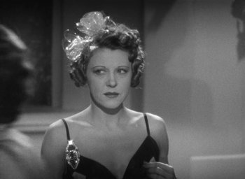 Movie still from “Dodsworth” (1936), directed by William Wyler – A black and white photo of a woman with a flower in her hair; Close Up shot, Low angle