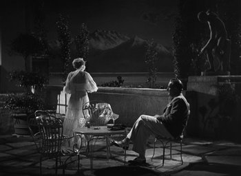 Movie still from “Dodsworth” (1936), directed by William Wyler – A man and a woman sitting at an outdoor table; Wide shot, High angle