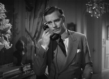Movie still from “Dodsworth” (1936), directed by William Wyler – A black and white photo of a man talking on a phone; Close Up shot, High angle