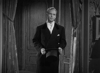 Movie still from “Dodsworth” (1936), directed by William Wyler – A black and white photo of a man in a suit and tie; Medium shot, Low angle