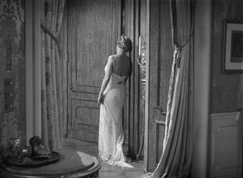 Movie still from “Dodsworth” (1936), directed by William Wyler – An old photo of a woman standing in a doorway; Wide shot, High angle