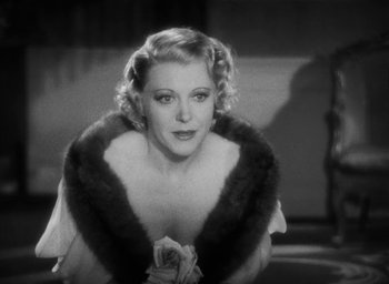 Movie still from “Dodsworth” (1936), directed by William Wyler – An old photo of a woman in a dress and a fur stole; Close Up shot, Low angle